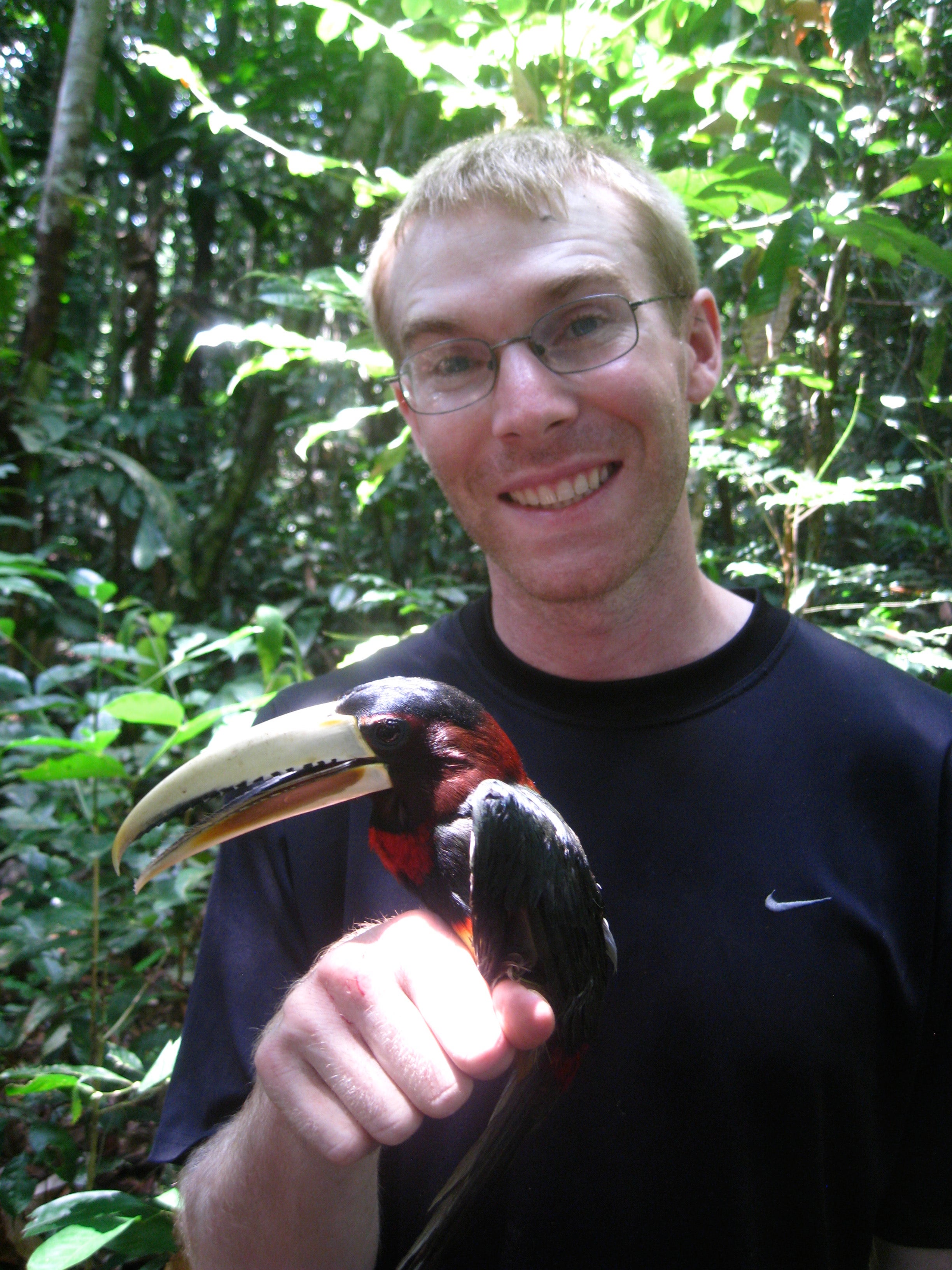 Photo of James Mouton holding a bird. 