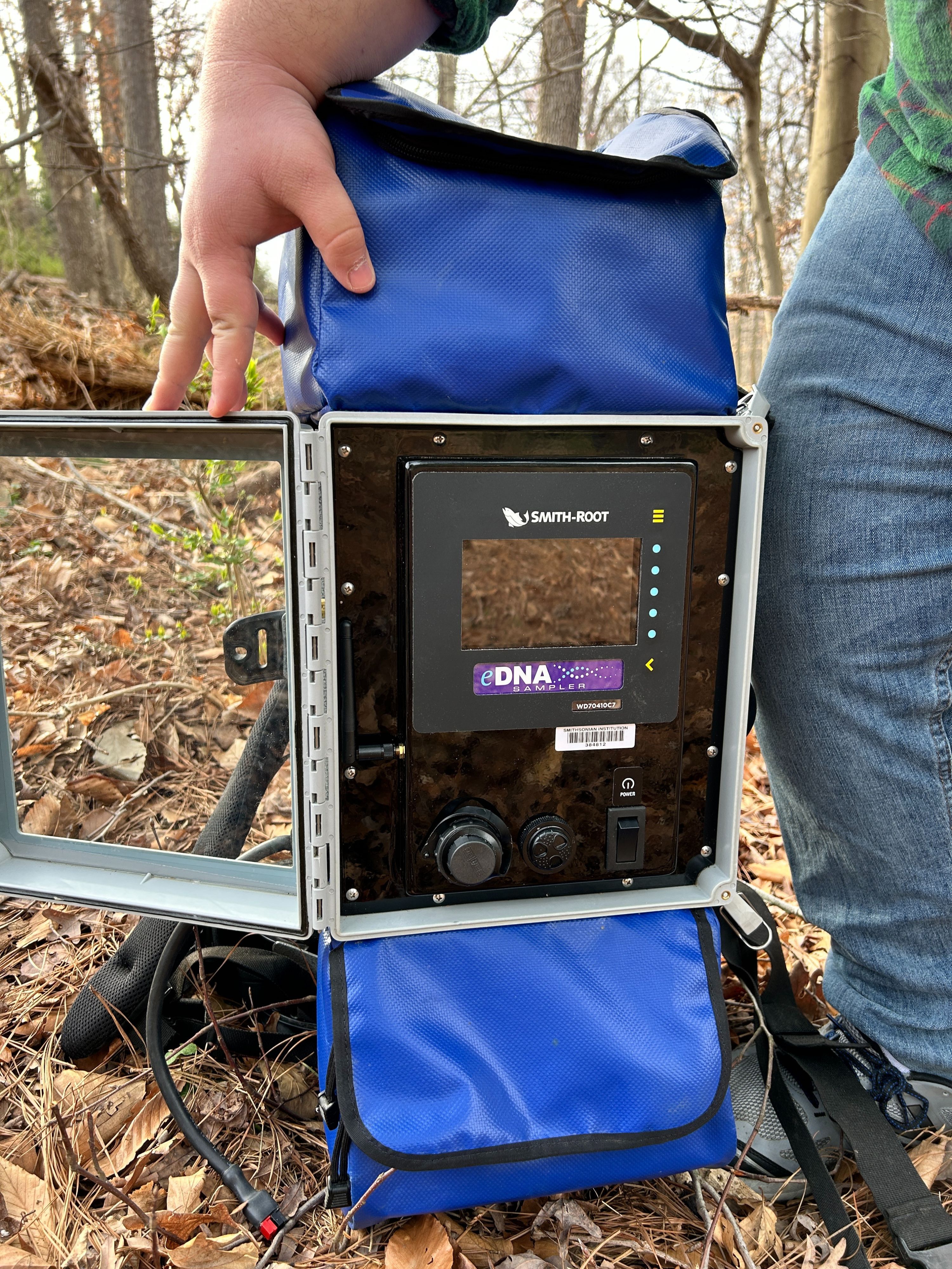 A photo of the eDNA testing device Sean uses in the field. The machine is set into a backpack of sorts so the user can carry it on their back. 