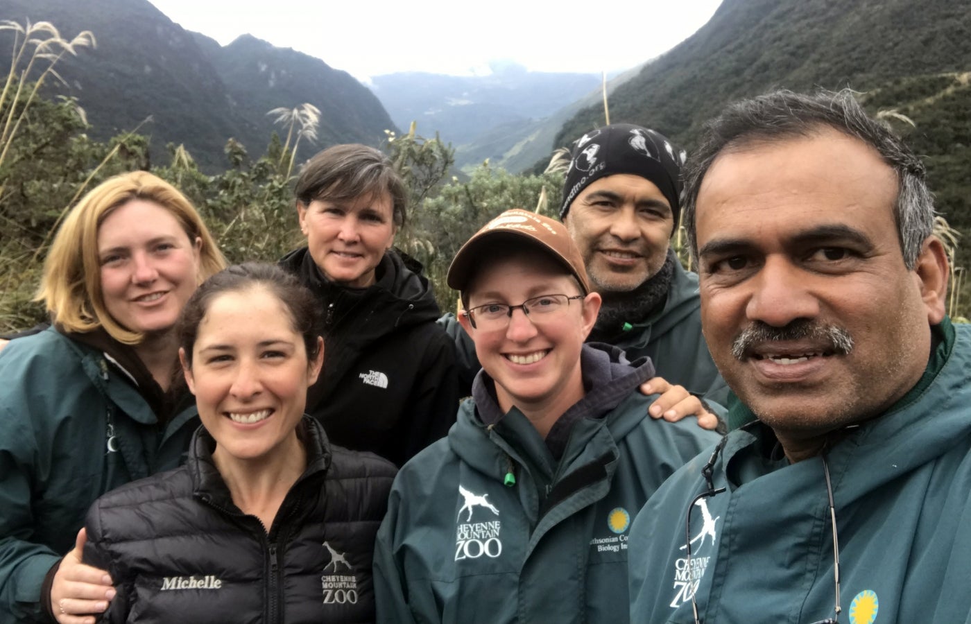 A group of six scientists pose for a photo in front of mountains during a tapir research expedition in Ecuador