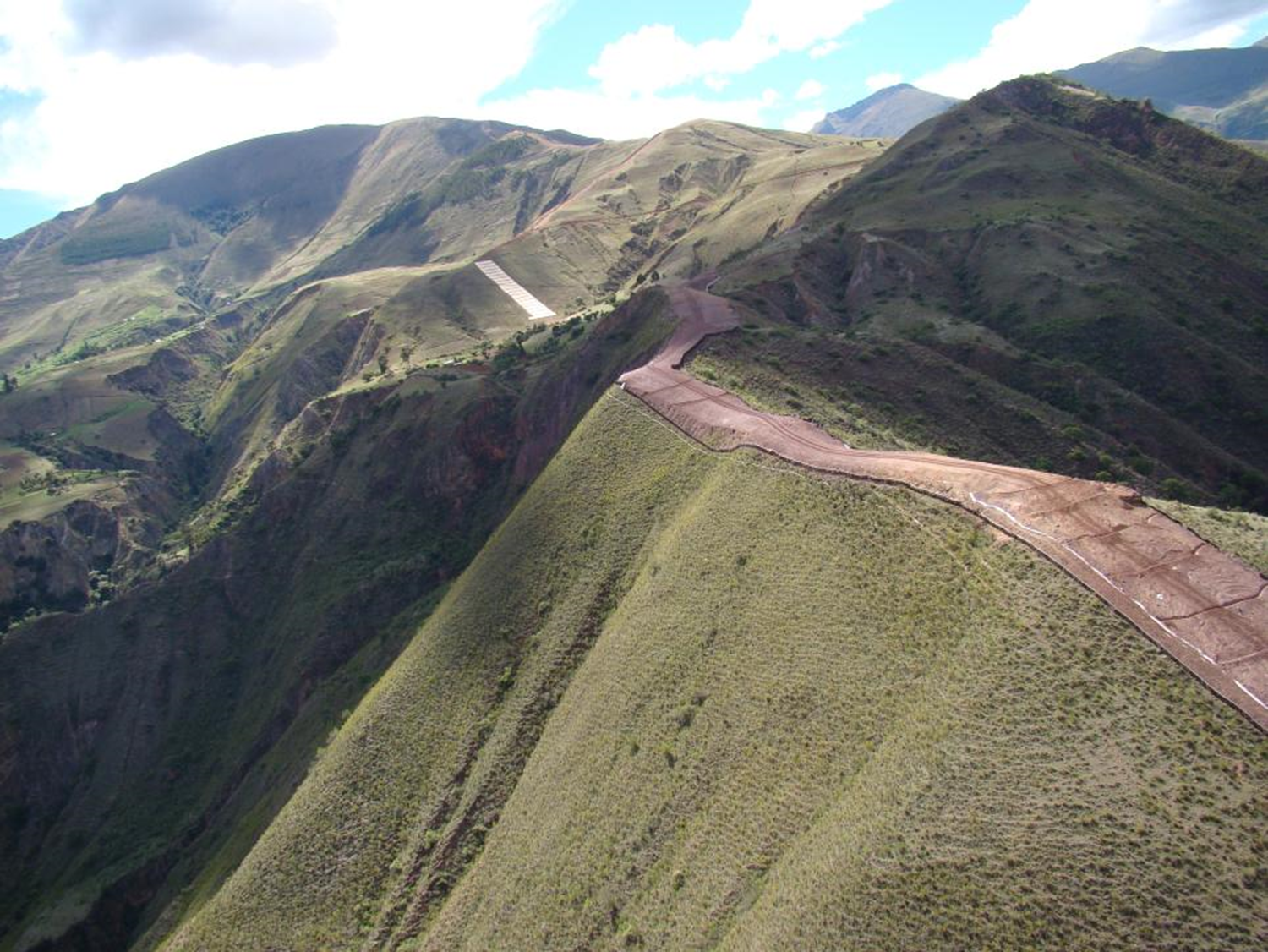 A road for pipeline development (right-of-way) on a steep ridgeline in the Andean mountains