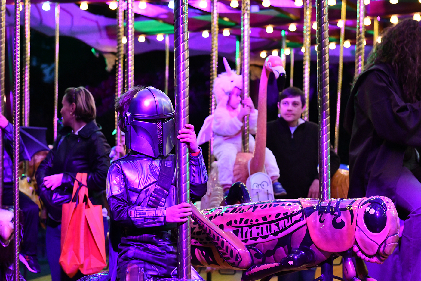 A child dressed as a Star Wars character rides the carousel at Boo at the Zoo.