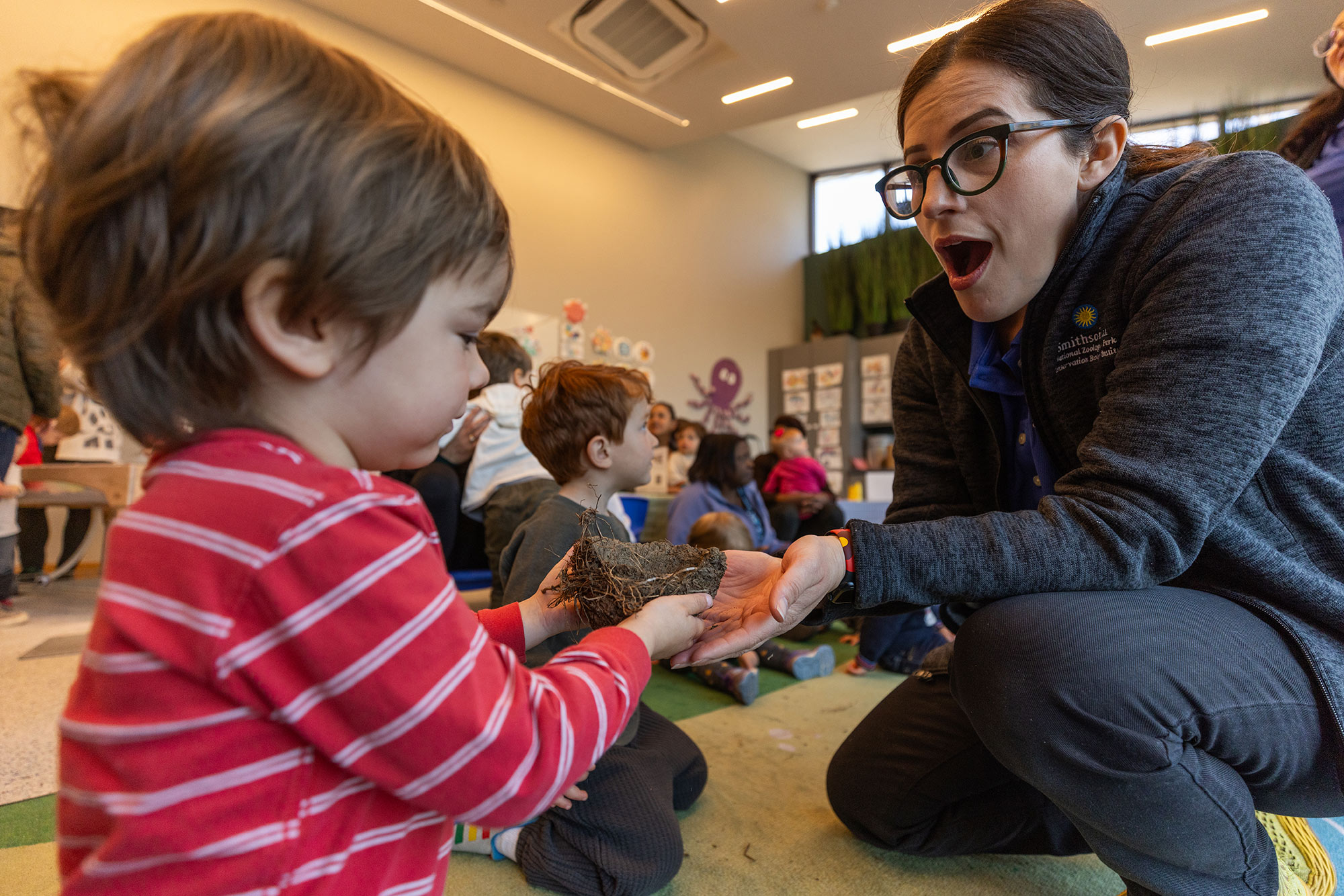 Education Programs Facilitator Laura Hernandez of the "Little Critters" program with a participant. This was an event in March 2024 celebrating the first year of being open for programming.
