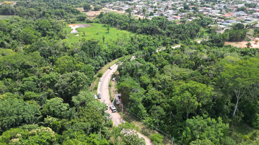 Aerial view of a road cutting through the Amazon Rainforest toward the Brazilian city of Alta Floresta