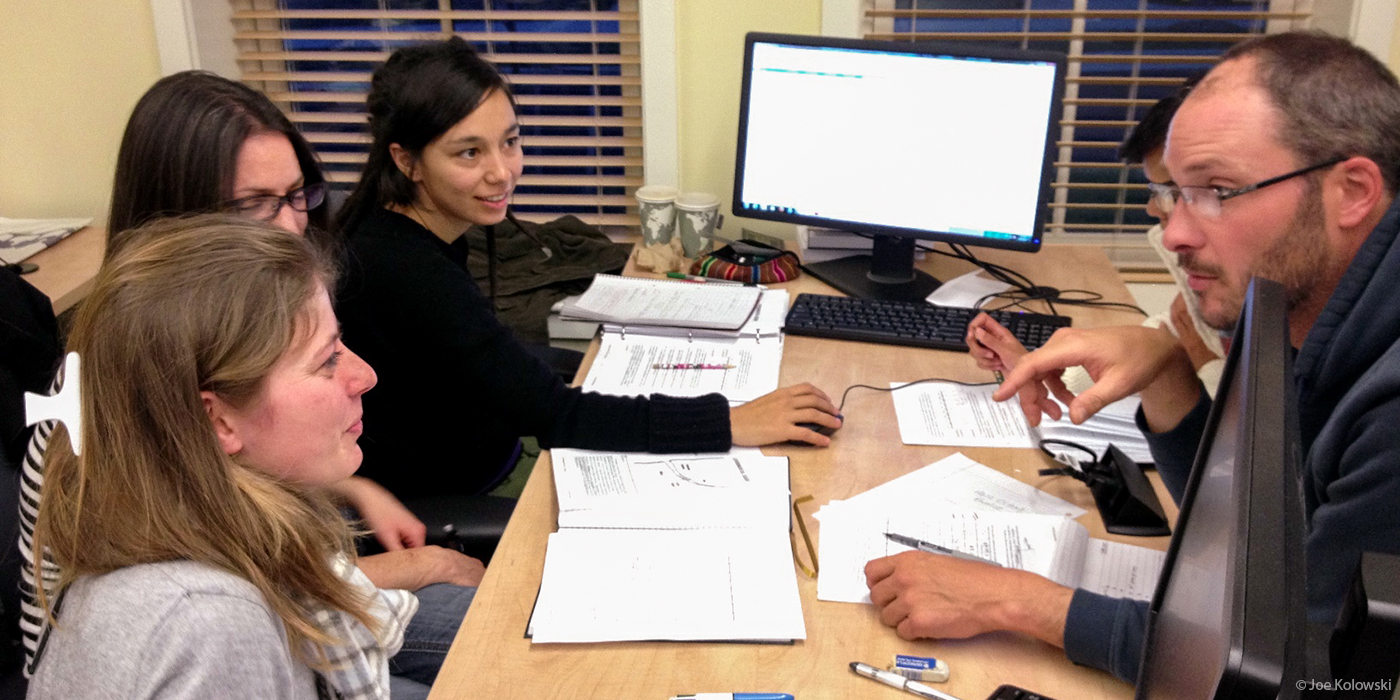 students sitting at a table having a discussion