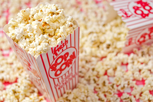 box of popcorn with popcorn in the background