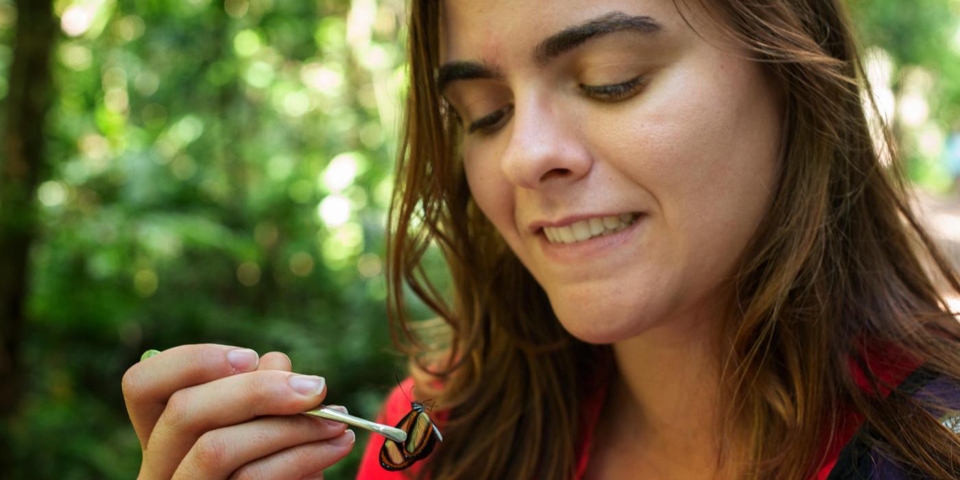 A BMAP Course participant examines a butterfly. 