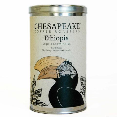 a coffee tin with an image of a Silvery-cheeked Hornbill surrounded by leaves
