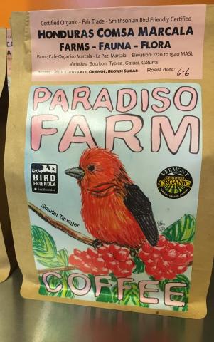 a coffee bag with a hand drawn illustration of a Scarlet Tanager perching on a coffee plant