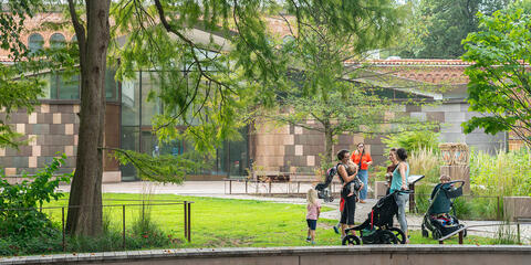 Visitors hang out on the grassy lawn near the Bird House.