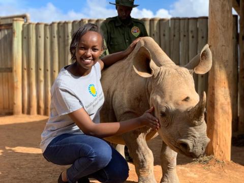 Global Health Program wildlife veterinarian Maureen Wanjiku Kamau with a young rhinocerous