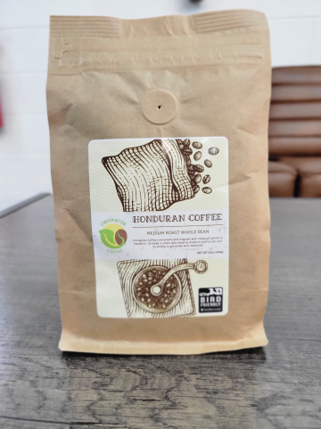 a coffee bag with an image of a burlap coffee bag filled with coffee beans and a hand coffee grinder