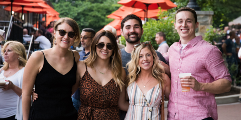 A group of guests pose for a photo at the Smithsonian's National Zoo's ZooFari event