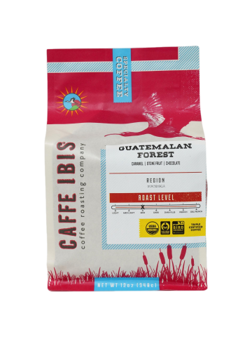 a coffee bag with an image of an Ibis flying above a wetland