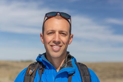 A head shot of ecologist Andy Boyce in the field at the American Prairie Reserve in Montana