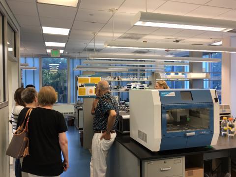 A group of people touring a genomics lab