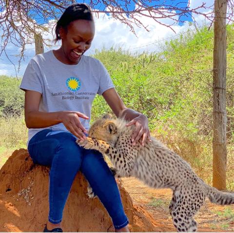 Global Health Program veterinarian Dr. Maureen Kamau and cheetah cub Pink. 