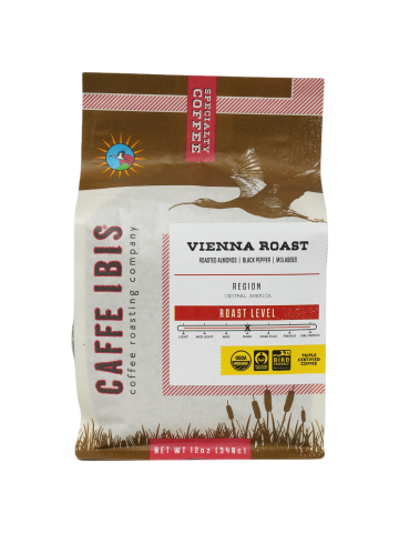 a coffee bag with an image of an Ibis flying above a wetland