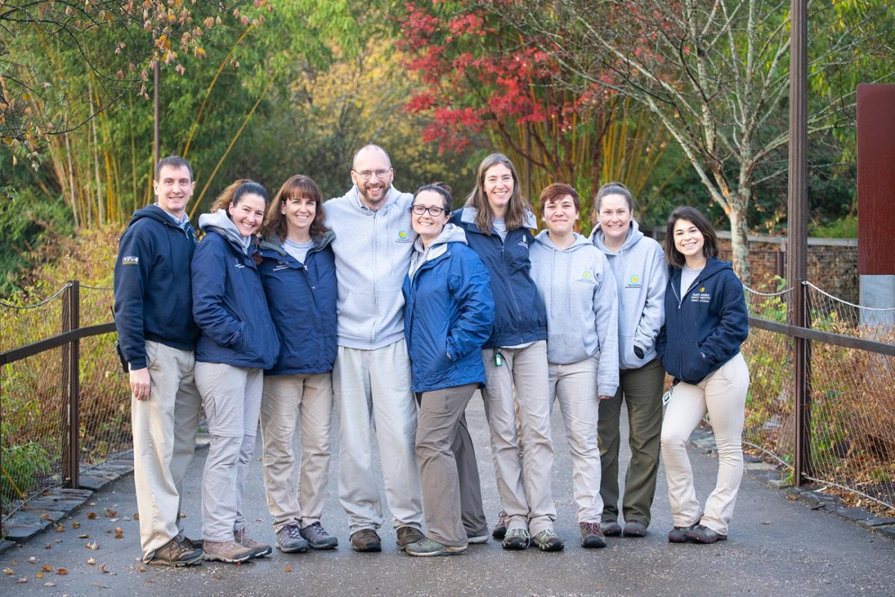 Members of the Zoo's giant panda team pose together for a photo on an exhibit pathway