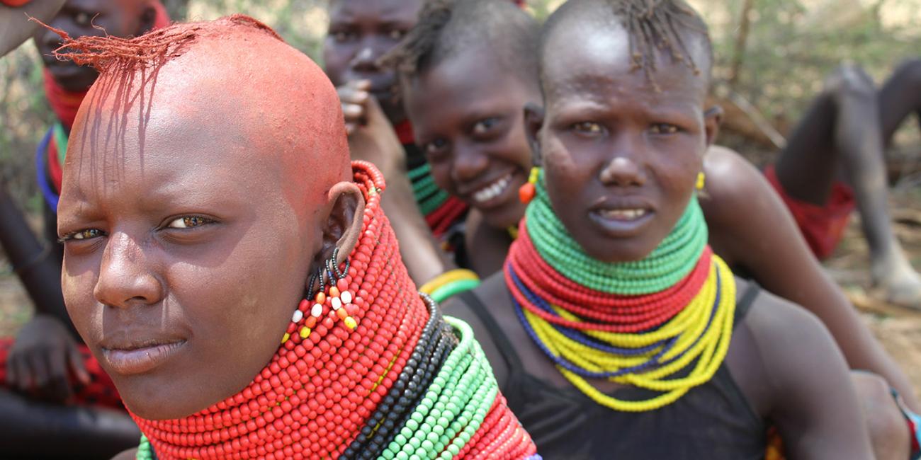 A group of Turkana girls in Kenya wearing brightly colored beaded necklaces