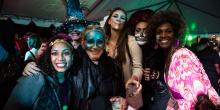 A group of six women dressed up in Halloween costumes and face paint pose for a photo at Night of the Living Zoo