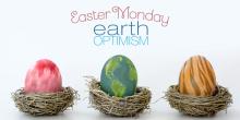 Three eggs sit in individual dry-grass nests. One looks like feathers, the other like the earth and the third one looks like a tiger's stripes. The words "Easter Monday and Earth Optimism" are at the top.