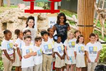 US First Lady Michelle Obama and Chinese First Lady Peng Liyuan pose with a group of school children after naming giant panda Bei Bei