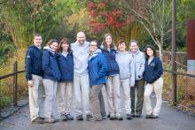 Giant panda team poses together for a photo on an exhibit pathway at the Zoo