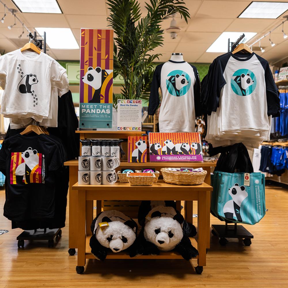 A store filled with colorful panda apparel and plush toys.