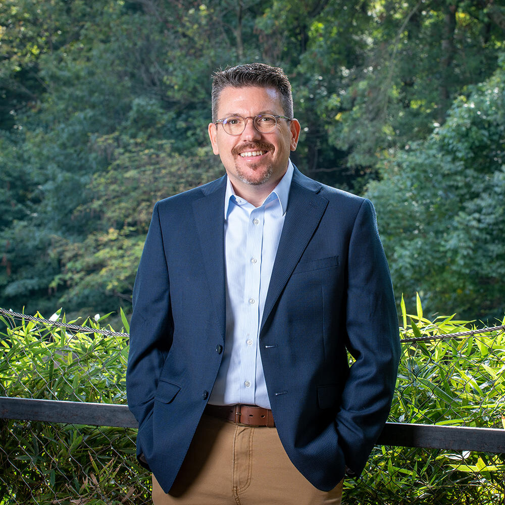 Man in a dark blue jacket.