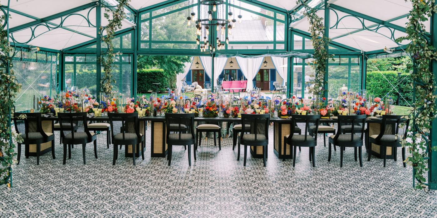 The interior of a garden tent, set for an event.