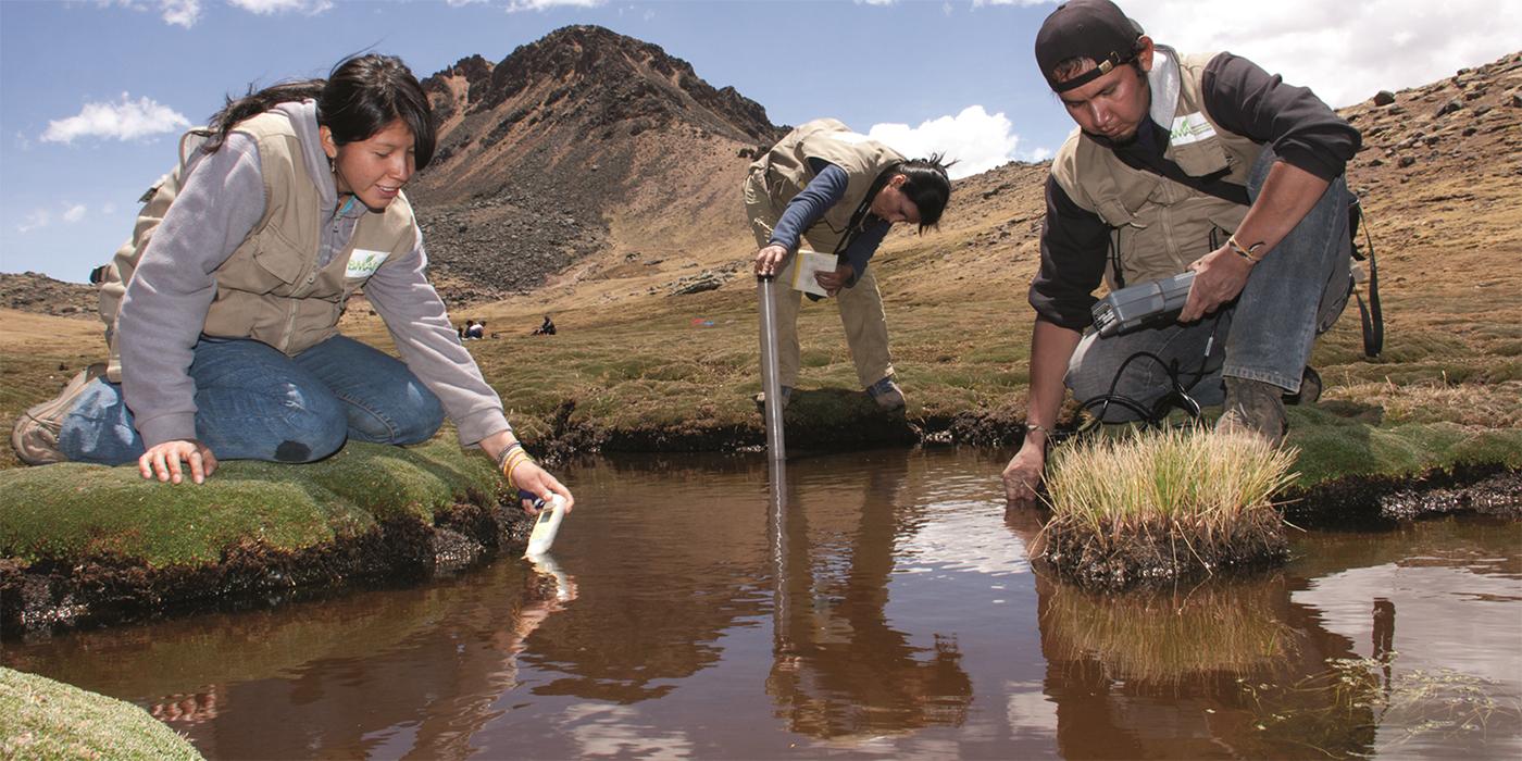 three researchers collecting water samples