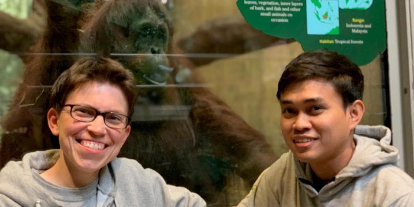 Curator of primates Meredith Bastian and international exchange student Dr. Jati in front of the Smithsonian's National Zoo's orangutan habitat