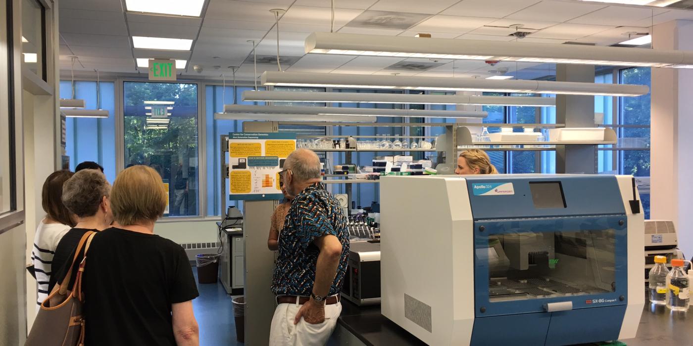 A group of people touring a genomics lab