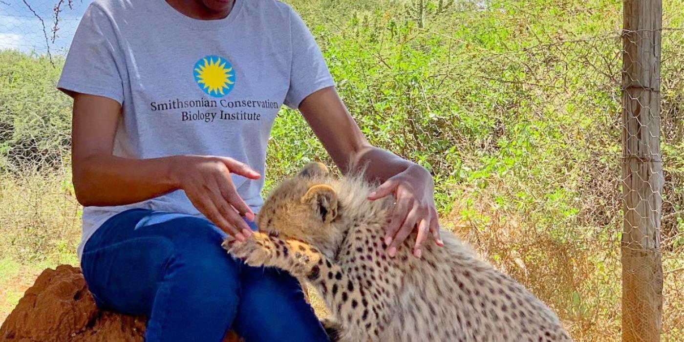 Global Health Program veterinarian Dr. Maureen Kamau and cheetah cub Pink.